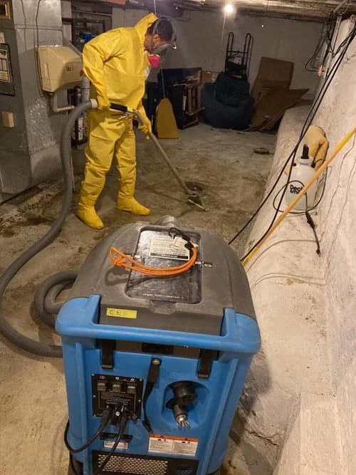 A team member from Cleveland Water and Fire in full PPE. Sewage cleanup in Bedford Ohio