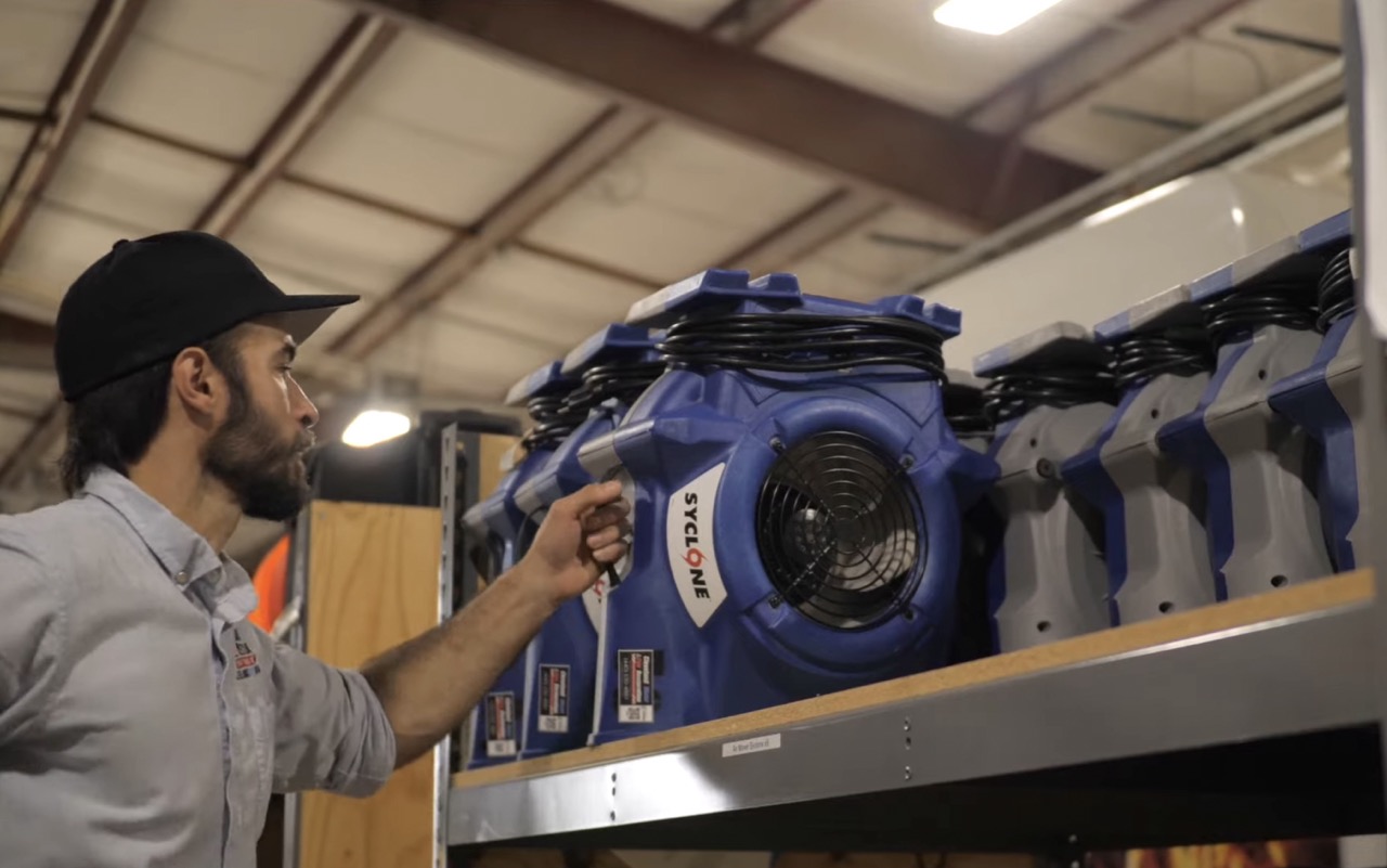 CWFR technician with industrial drying equipment
