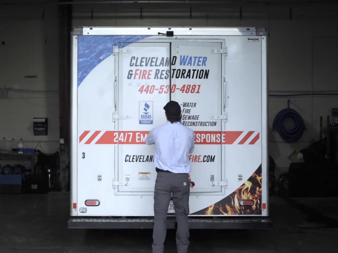 A team member from Cleveland Water and Fire loads work truck